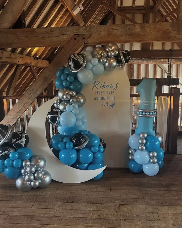 A moon-themed first-birthday balloon installation by PD Events